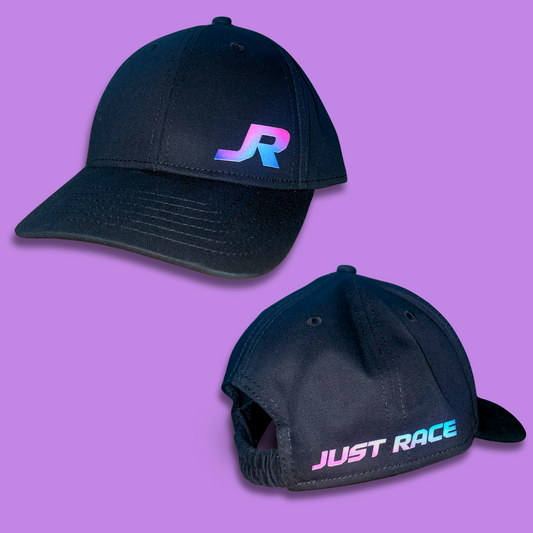 black baseball cap featuring “JR” logo in bright pink, blue and purple. The back of the hat carries the words “Just Race”. JR is an experienced car tuner who specialises in tuning drag cars, off-street racing and no-prep events in Australia.